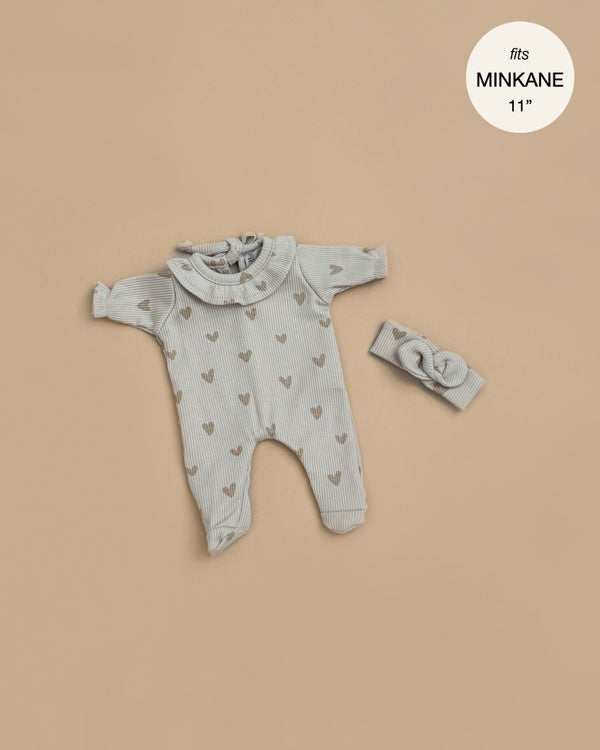 Minikane 11" Doll Clothing | Camille Onesie & Headband in Ribbed Cotton - Beige Hearts: A gray ribbed long-sleeve romper with ruffled collar and heart pattern, plus matching headband. Displayed on tan background. Text reads "fits 11\" Babies dolls".