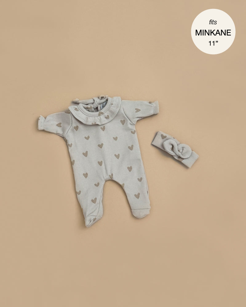 Minikane 11" Doll Clothing | Camille Onesie & Headband in Ribbed Cotton - Beige Hearts: A gray ribbed long-sleeve romper with ruffled collar and heart pattern, plus matching headband. Displayed on tan background. Text reads "fits 11\" Babies dolls".