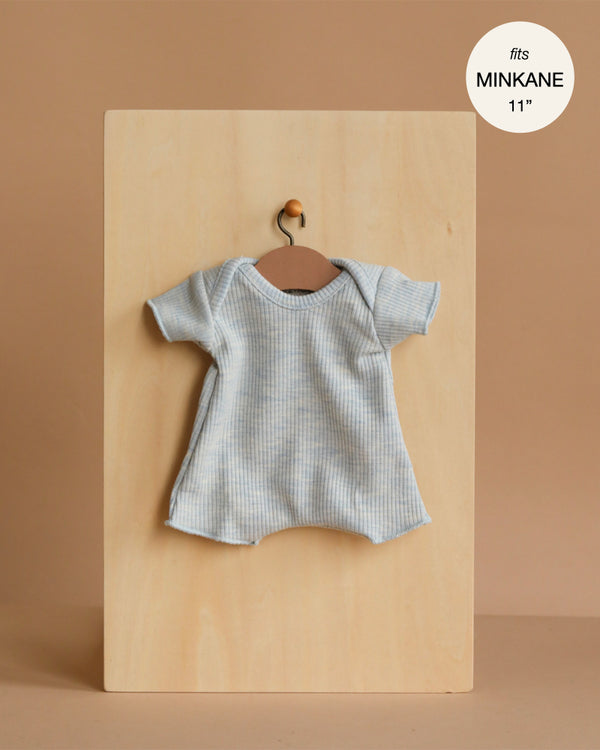 The Minikane 11" Doll Clothing | Shorty Bodysuit in Ribbed Cotton - Heather Blue is a stylish, short-sleeved, light blue ribbed knit bodysuit for Minikane Babies—perfect doll clothes for playtime.