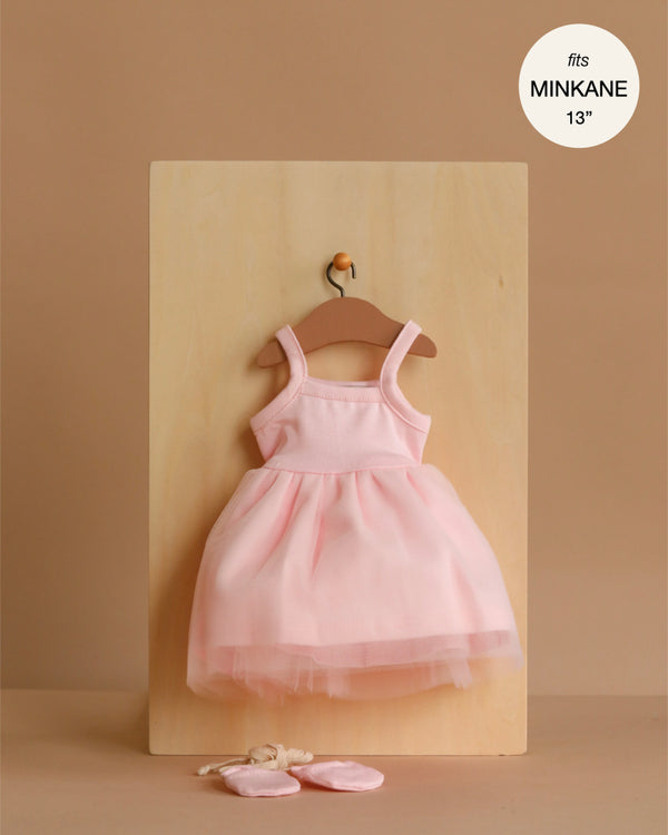 The Minikane 13" Doll Clothing Rosella Tutu in pale pink features a sleeveless dress with a tulle skirt and matching ballet shoes, perfect for 13" dolls. A circle label reads "fits MINIKANE 13".