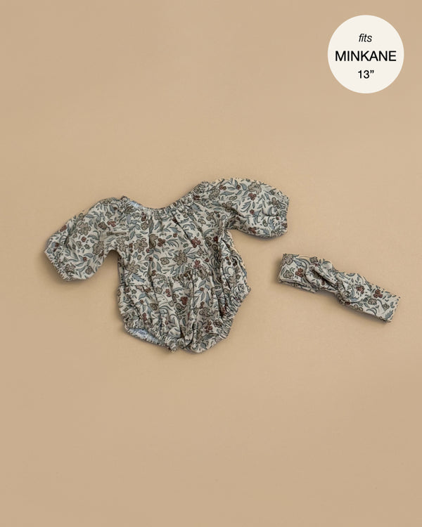 The Minikane Doll Clothing | Rylee+Cru | Bertille Romper and Headband - Autumn Flowers fits 13" Minikane dolls. This floral long-sleeve romper with matching headband is shown on a beige background, ideal for your favorite Minikane doll.