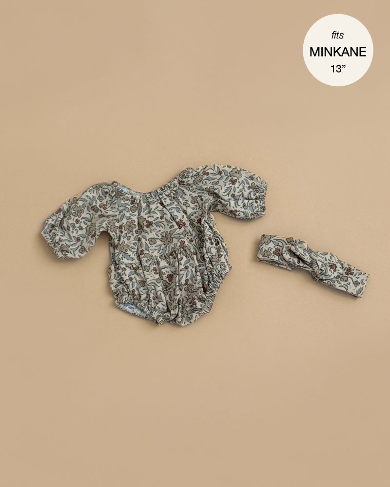The Minikane Doll Clothing | Rylee+Cru | Bertille Romper and Headband - Autumn Flowers fits 13" Minikane dolls. This floral long-sleeve romper with matching headband is shown on a beige background, ideal for your favorite Minikane doll.