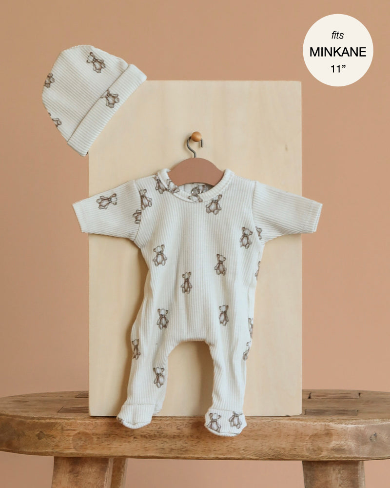 The Minikane 11" Doll Clothing | Sleep Tight Angel Onesie & Hat in Ribbed Cotton - Little Bears features a cream ribbed footed onesie with brown teddy bear print and matching beanie, perfect for Minikane dolls. Premium doll clothes made in France.