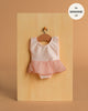 The Minikane 13" Doll Clothing | Ludmila Ruffled Leotard in Nude Pink lycra and chiffon with a sheer skirt hangs on a wooden hanger against a light wood board. Text reads: "fits Minikane Gordis dolls 13”.