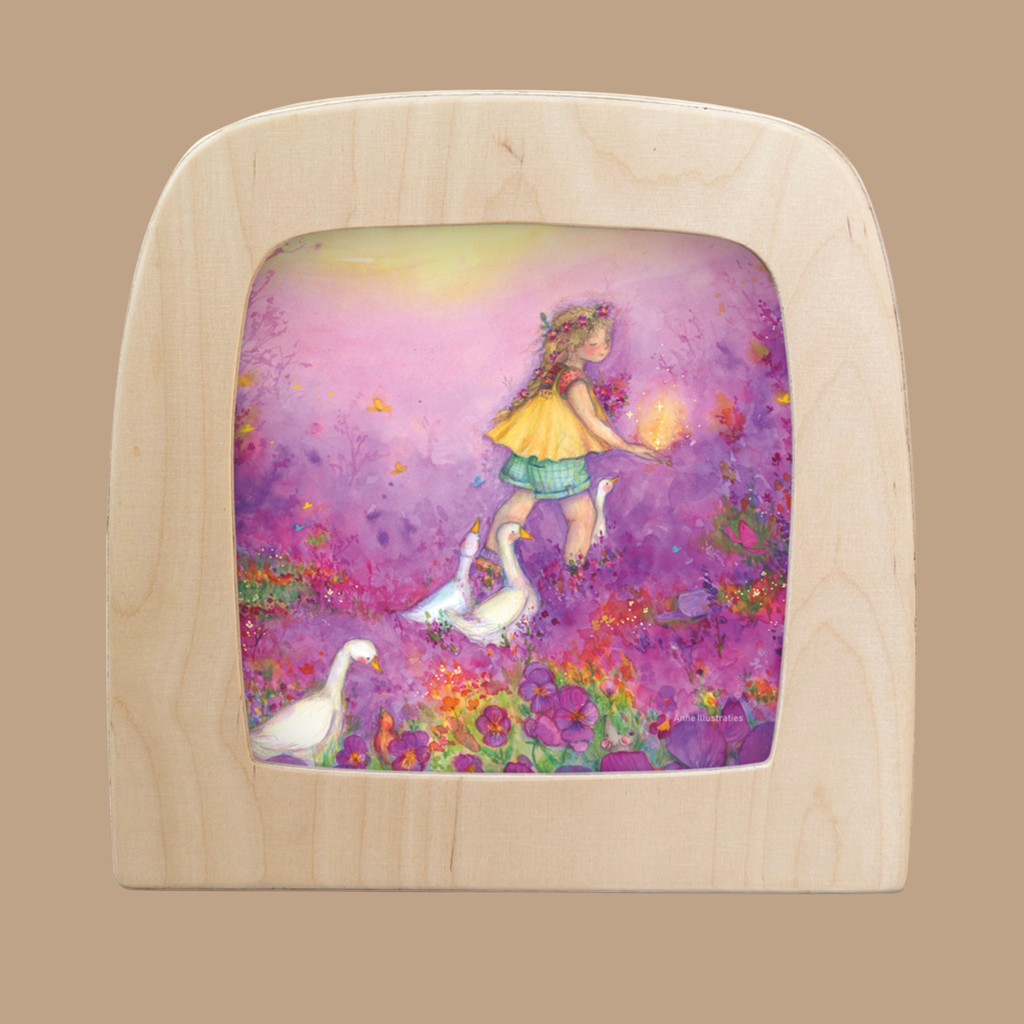 A charming silhouette for the Toverlux Lamp shows the Little Goose Girl in a yellow dress with three geese and a lantern, surrounded by bright flowers and butterflies. Product: Silhouette Only - Little Goose Girl Silhouette for Toverlux Lamp.