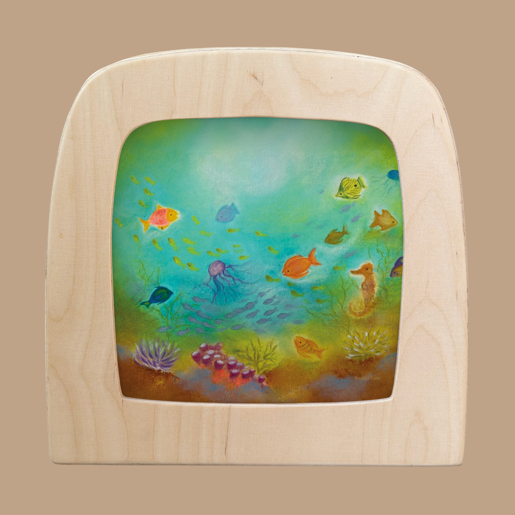 The Silhouette Only - Underwater World for Toverlux Lamp features vibrant fish, a jellyfish, seahorse, and coral on a wooden frame with a green-blue gradient background evoking the magic of the ocean floor.