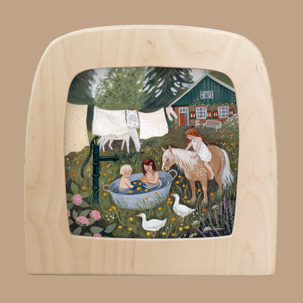 A charming silhouette for the Toverlux Lamp features two children bathing outdoors, a third on a horse, geese, marigold flowers, and a red house with laundry—capturing the whimsical scene of "Silhouette Only - Marigold.