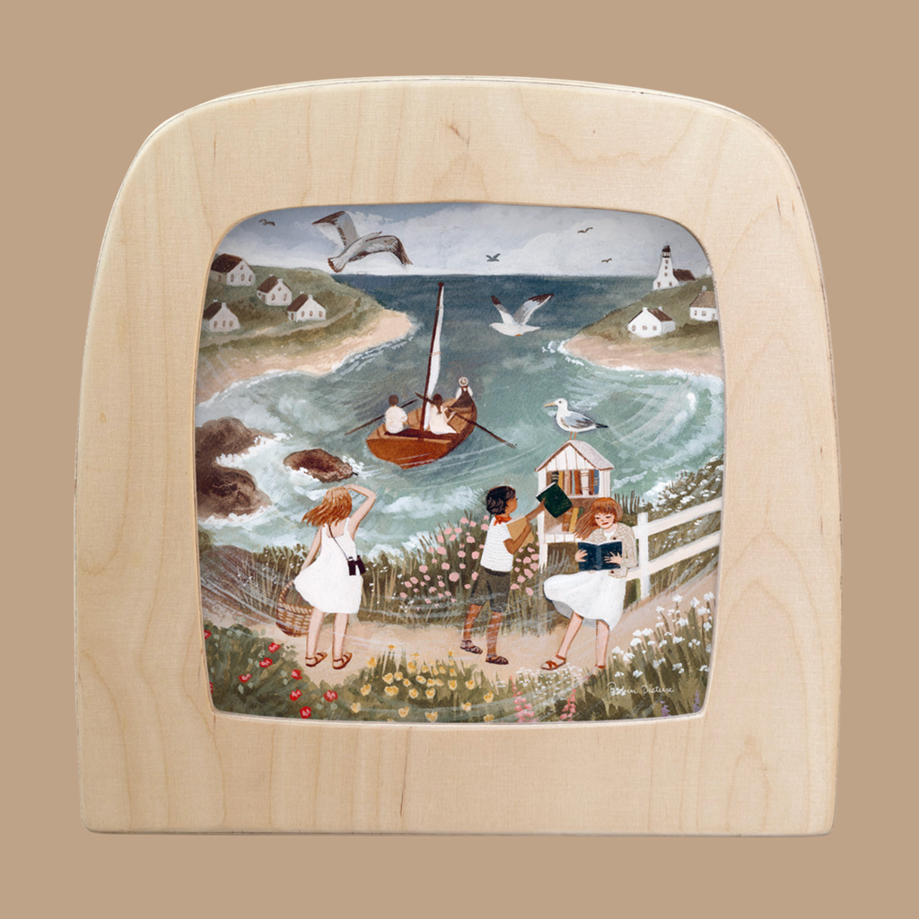 The Silhouette Only - Seaside for Toverlux Lamp features an illustrated scene of three people walking along a seaside path, with a boat at sea, seagulls overhead, a distant lighthouse, and charming houses on grassy hills under cloudy skies.
