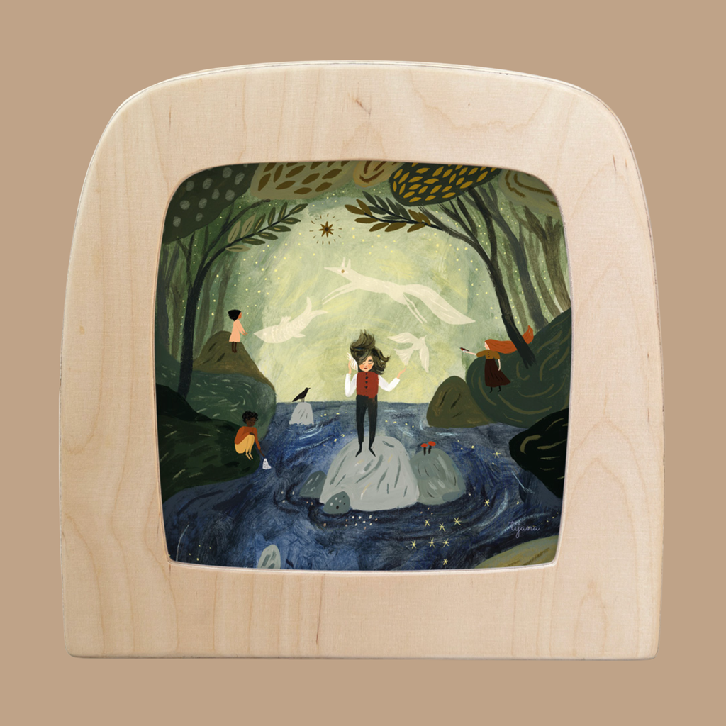 A whimsical light wood-framed illustration shows a person on rocks in a stream, with trees, animals, children, and glowing stars featuring the Silhouette Only - Seashell for Toverlux Lamp in the night sky.