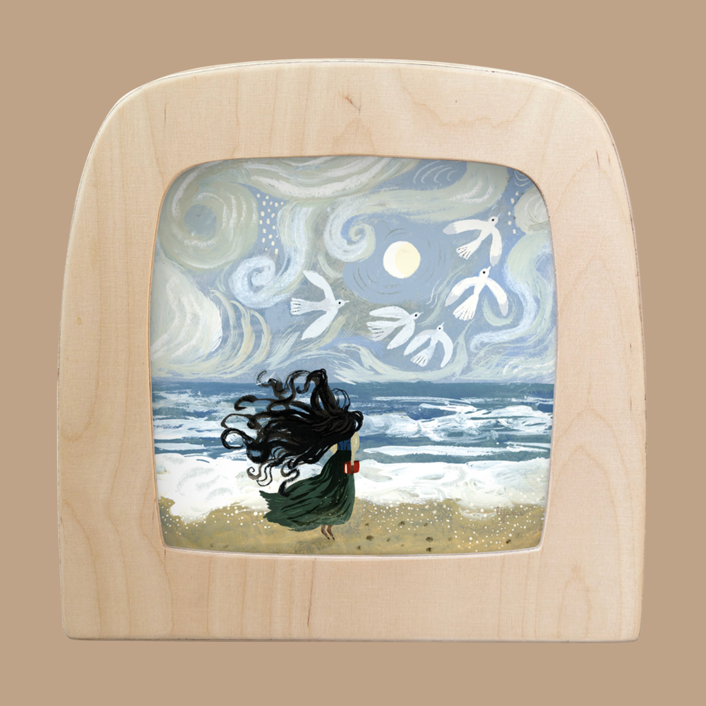 A light wood-framed "Silhouette Only - Tide for Toverlux Lamp" shows a girl with flowing black hair on a beach, facing wavy seas and a swirling sky as white birds circle a bright sun or moon, recalling Magic Silhouettes.
