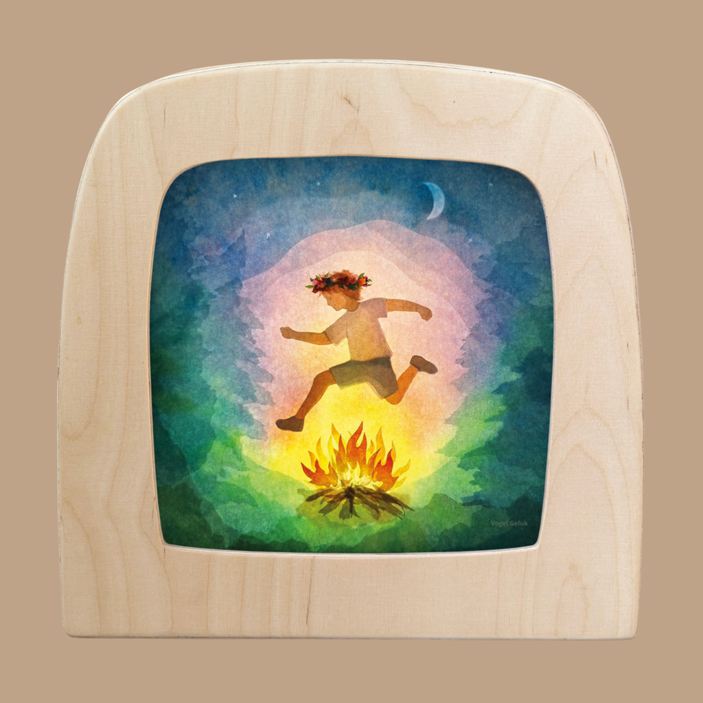 A vibrant silhouette for the Toverlux Lamp, "Courage," shows a joyful figure with a flower crown leaping over a glowing campfire under a crescent moon, capturing whimsy and bravery in your space.