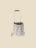 The Maileg Trolley, Multi dots - Blue is a small wheeled trolley with a washable linen bag in colorful polka dots, gray interior, and gray handle, shown against a plain beige background.