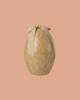 The Maileg Easter Egg, Medium - Cream Yellow, features a white floral pattern and cream ribbon, displayed on a peach background.