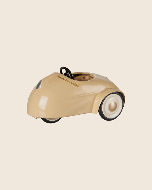 The PRE-ORDER: Maileg Car, Mouse - Wheat is a small, beige vintage-style metal car with white wall tires and "dream car rental" on the side—ideal as a pull-along toy. Estimated arrival mid August. Displayed against a plain light background.