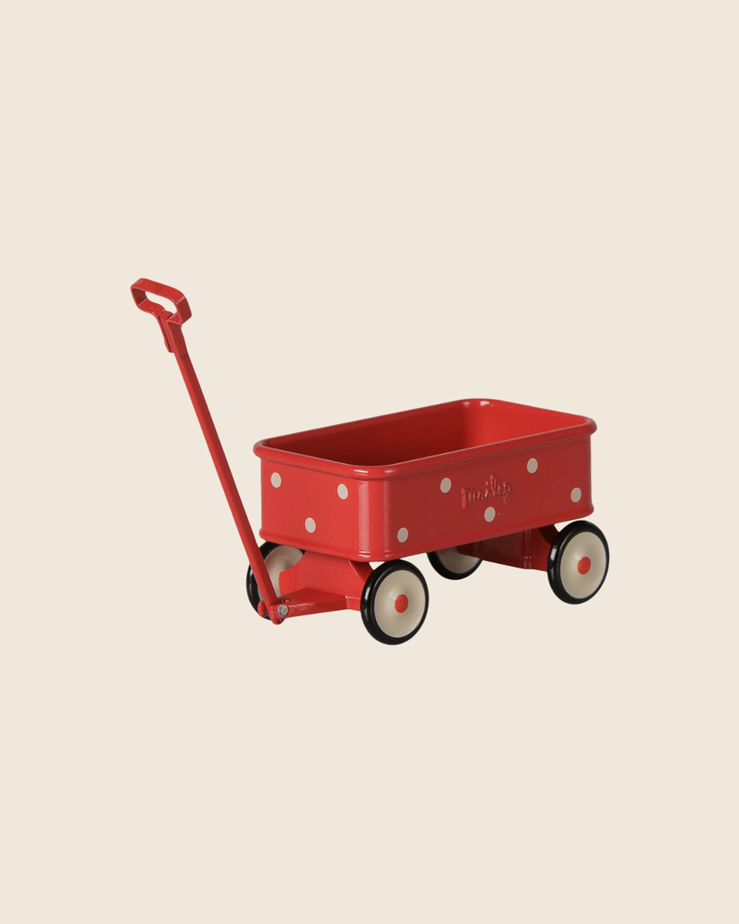 PRE-ORDER: Maileg Wagon, Mouse - Red, a small metal toy wagon with white polka dots, black-and-white wheels, and a long handle—perfect for mouse family accessories. Estimated arrival mid September. Shown on a beige background.