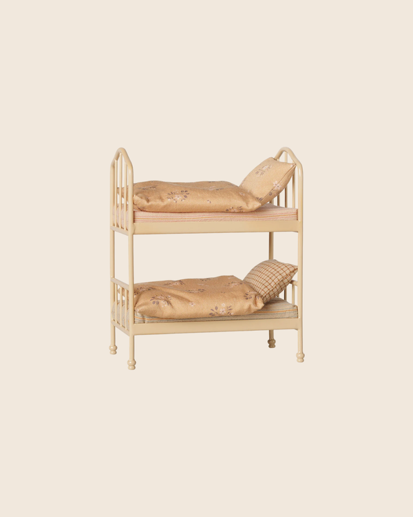 The PRE-ORDER: Maileg Bunk Bed, Mouse - Wheat features a compact cream-colored metal frame with two mustard mattresses, each with a pillow and blanket—perfect for sleepover play. Estimated arrival mid August. Set on a plain beige background.