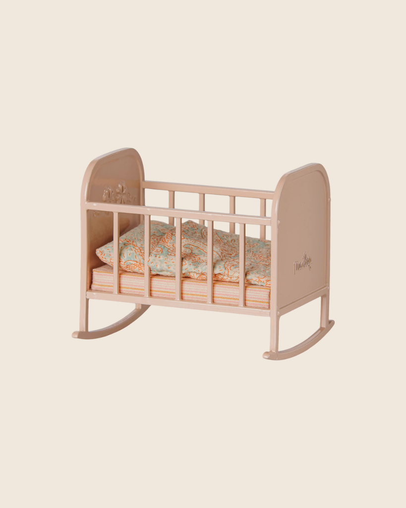 The PRE-ORDER: Maileg Cradle, My - Light Rose (Estimated Arrival Early September) is a small, lightweight rose cradle featuring a floral-patterned mattress and pillow, set against a plain beige background.