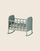 PRE-ORDER: Maileg Cradle, My - Blue Mint features a small, light blue-green cradle with vertical slats, patterned bedding, and curved rockers. Estimated arrival mid August. Photographed against a plain beige background.