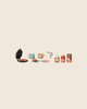 The PRE-ORDER: Maileg Waffle Set, Mouse (Estimated Arrival Mid October) features an open waffle maker with waffles, cups, saucers, a plate, pitcher, honey jar, jam, and cocoa can—all neatly arranged on a light background.
