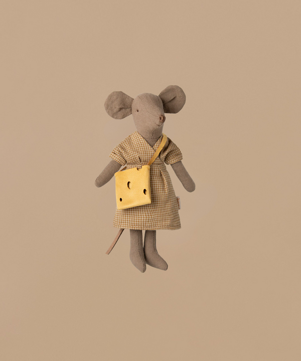 The Maileg Mum Mouse - Light Brown wears a checkered dress and carries a yellow cheese-shaped bag. Made of soft cotton, this charming toy rests against a plain beige background, adding warmth to any mouse furniture setup. (Ships in one week).