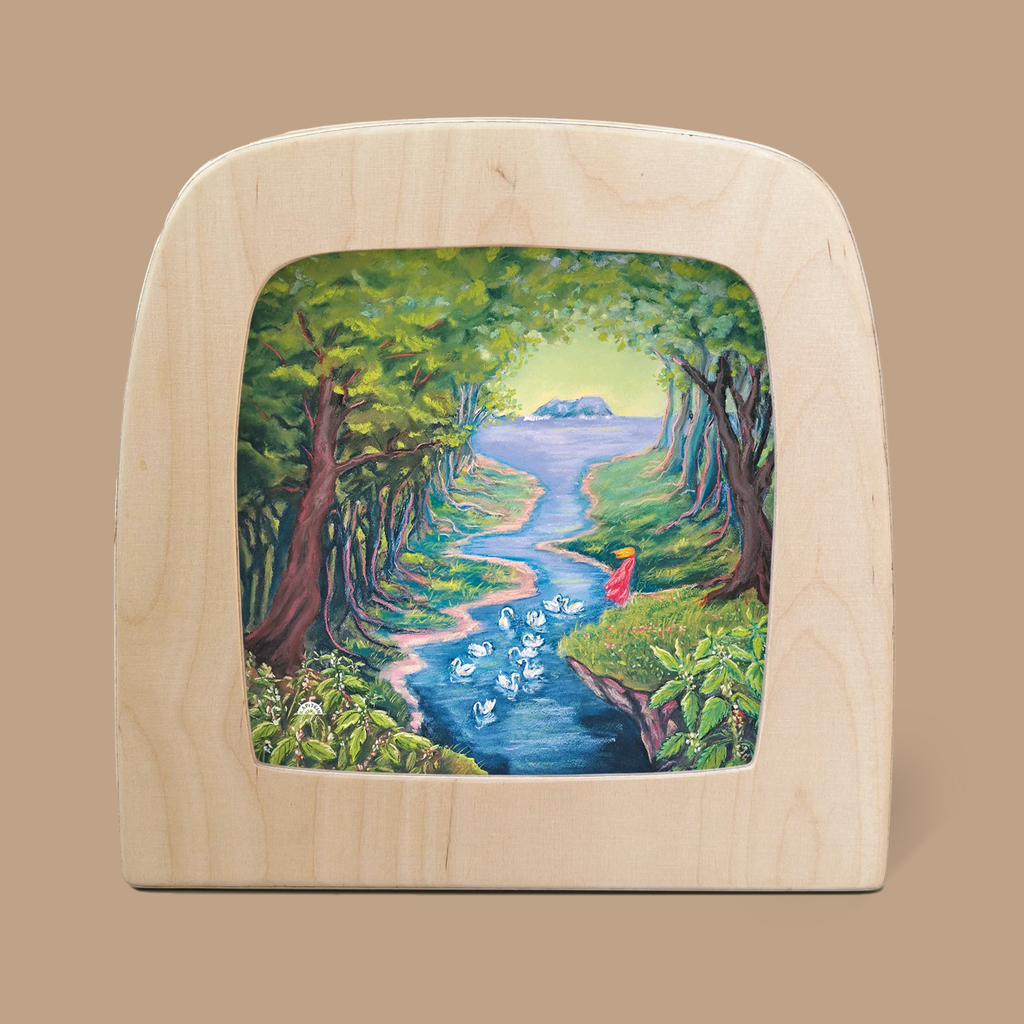 A captivating example of Magic Silhouettes, the 'Silhouette Only - Wild Swans for Toverlux Lamp' features a colorful depiction of a figure in red by a winding stream, surrounded by trees and swans beneath radiant sunlight.