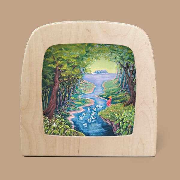 A captivating example of Magic Silhouettes, the 'Silhouette Only - Wild Swans for Toverlux Lamp' features a colorful depiction of a figure in red by a winding stream, surrounded by trees and swans beneath radiant sunlight.