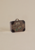 The Maile Bonus Room Bedroom Set includes a small vintage suitcase with a brown checkered pattern and travel stickers—ideal for accessorizing your Maileg dollhouse or adding charm to any miniature bedroom scene.