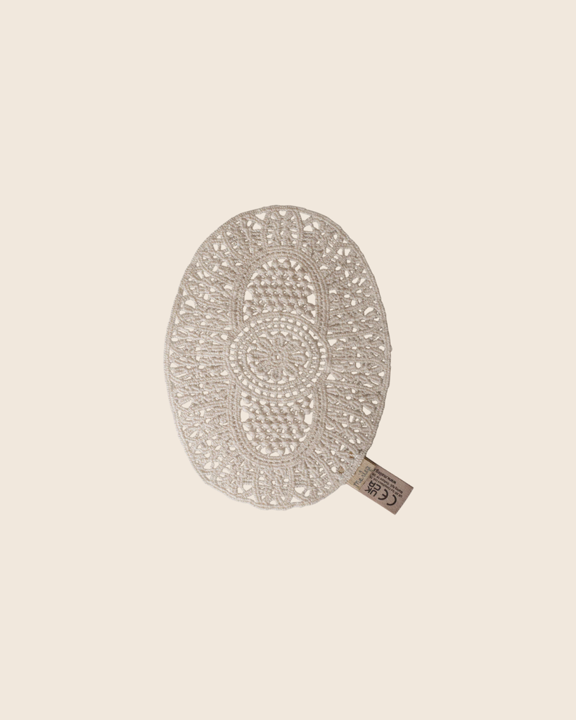PRE-ORDER: Maileg Lace Rug, Mouse—an oval, intricately crocheted off-white lace rug with fabric tag. Ideal for dollhouse decor or as a small accessory. Displayed on a beige background. Estimated arrival mid September.