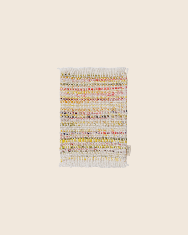 The PRE-ORDER: Maileg Rug, Mouse, Mini - Multi stripe is a small rectangular woven viscose polyester rug with multicolored stripes—mainly white with yellow, pink, and green accents—plus fringed short edges, shown on a plain beige background. Estimated arrival mid September.