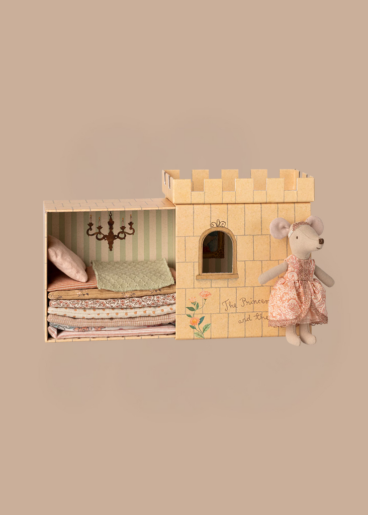 PRE-ORDER: Maileg Princess and The Pea, Big Sister Mouse features a princess mouse in a pink dress beside an open toy castle with stacked bedding, pillow, and small chandelier inside. Estimated ship date: mid November. Background is solid beige.