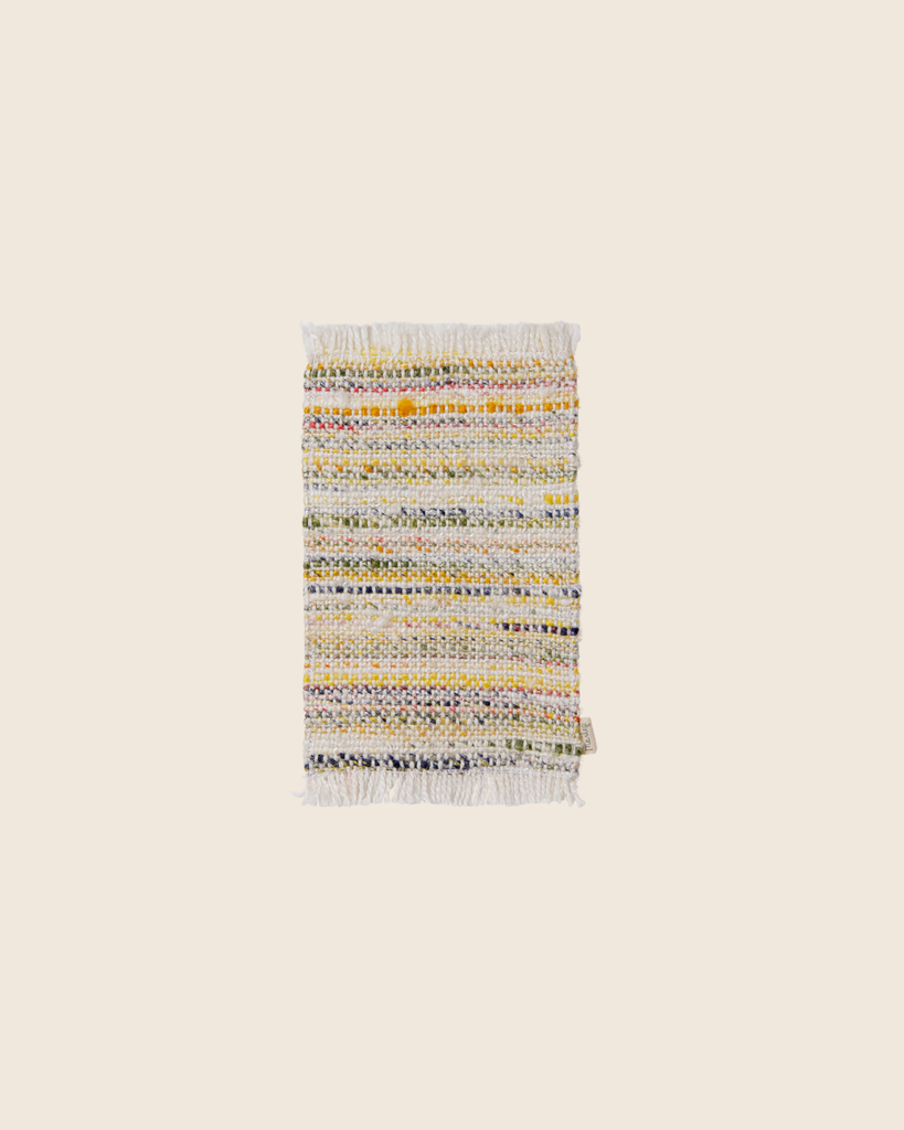 The PRE-ORDER: Maileg Rug, Mouse, Small - Multi Stripe (Estimated Arrival Mid September) is a small rectangular rug with multicolored stripes and white fringe on both ends, ideal for adding vibrancy to your space. Shown on a beige background.