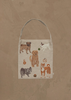 The Coral & Tusk Dogs and Toys Tote is a beige bag with embroidered images of six dog breeds and playful dog-themed items, all set on a plain brown textured background.
