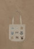 The Coral & Tusk Cats Tote Bag is a beige tote featuring nine illustrated feline faces arranged in a 3x3 grid on a textured brown background.