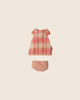 The PRE-ORDER: Maileg Dress, Teddy Junior - Coral (arriving early November) features a small pink and white checked dress with lace trim and matching pink polka-dotted bloomers, shown on a plain beige background.