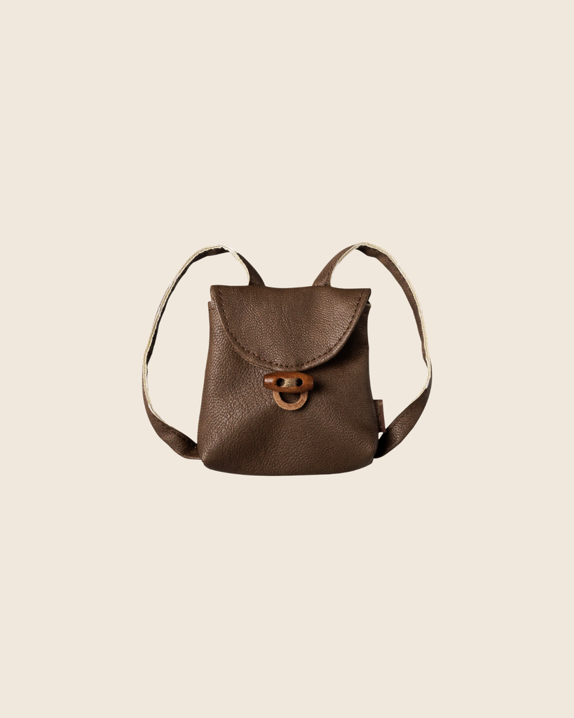 PRE-ORDER: Maileg Backpack, Medium Mouse—small brown leather backpack with front flap, wooden toggle closure, and two shoulder straps. Displayed on a beige background for a charming vintage look. Estimated arrival early November.