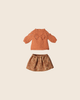 PRE-ORDER: Maileg Skirt and Knitted Sweater - Medium Mouse, featuring a small orange leaf-patterned sweater and flower skirt, both laid flat on a light beige background. Estimated arrival: early November.