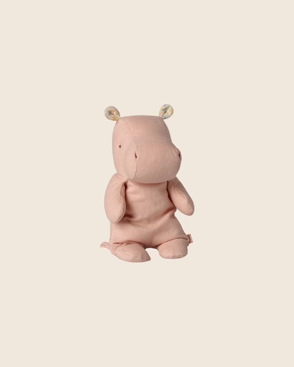 The PRE-ORDER: Maileg Safari Friends, Hippo, Small - Soft Rose sits upright against a beige background, featuring floral inner ears and a gentle pink hue—perfect to join your safari friends collection. Estimated arrival early November.
