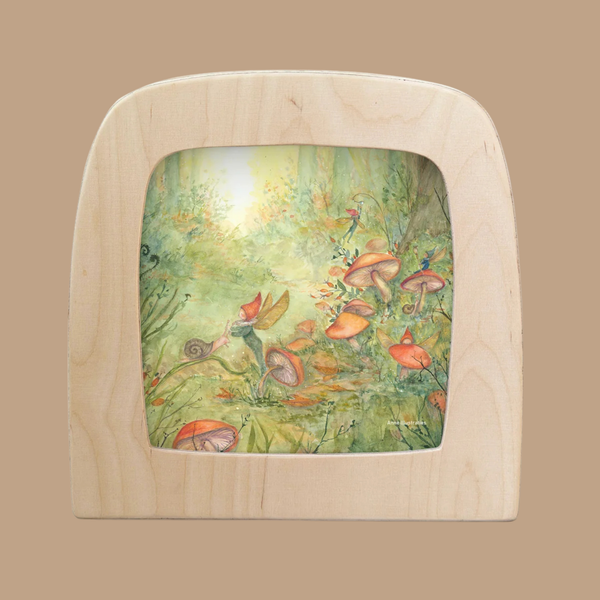 A Pixie Forest Silhouette, featuring a fairy, orange mushrooms, and lush greenery bathed in gentle sunlight, brings a magical touch to your Toverlux lamp—designed to enchant just like classic Toverlux magic silhouettes.
