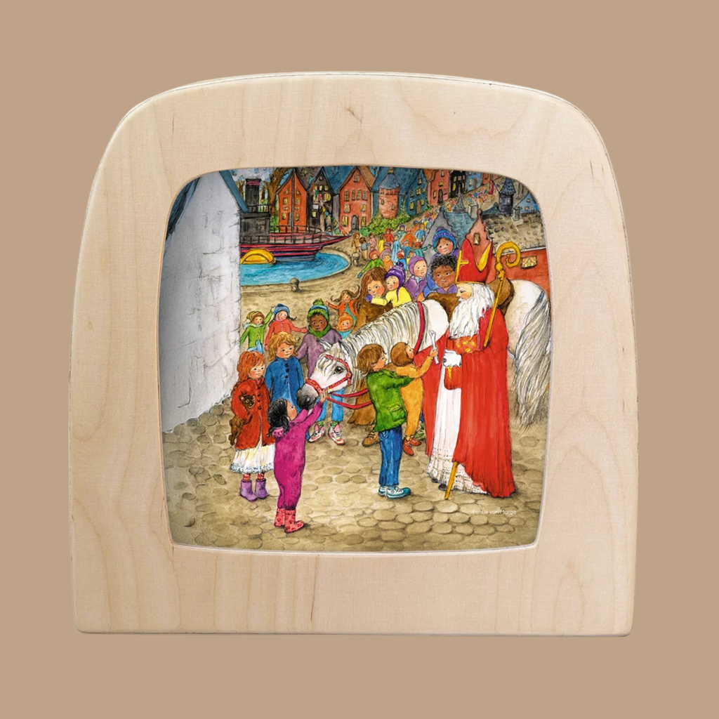 A vibrant silhouette entitled “Anticipation,” designed for the Toverlux Lamp, depicts Saint Nicholas with his horse as he warmly greets cheerful children dressed in winter attire by a waterfront village—a captivating piece from the Magic Silhouettes and Toverlux silhouettes collection, perfect for adding unique charm to your home decor.
