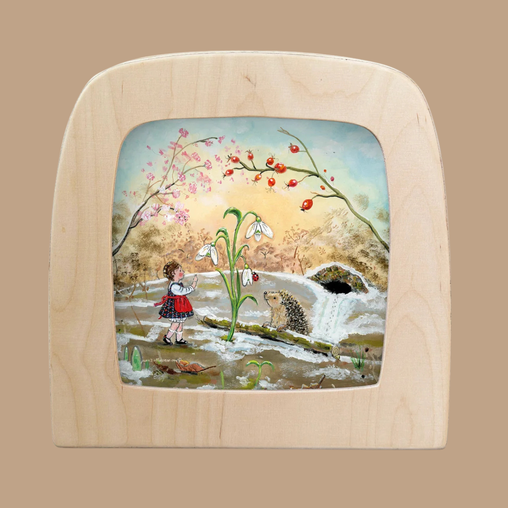 The “Silhouette Only - Out of Hibernation Silhouette for Toverlux Lamp” features a charming scene of a girl in a red skirt waving at a hedgehog near white flowers, with a river, trees, and sky in the background—perfect for adding unique decorative flair to your Toverlux lamp and enhancing any space.