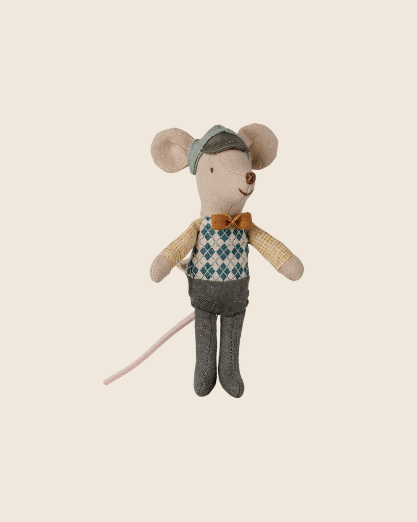 PRE-ORDER: Maileg Driver Mouse, Little Brother—dressed in a green cap, yellow plaid shirt, blue vest, bow tie, gray shorts, and socks—sits with his pink tail on a plain beige background. Estimated arrival: early September.