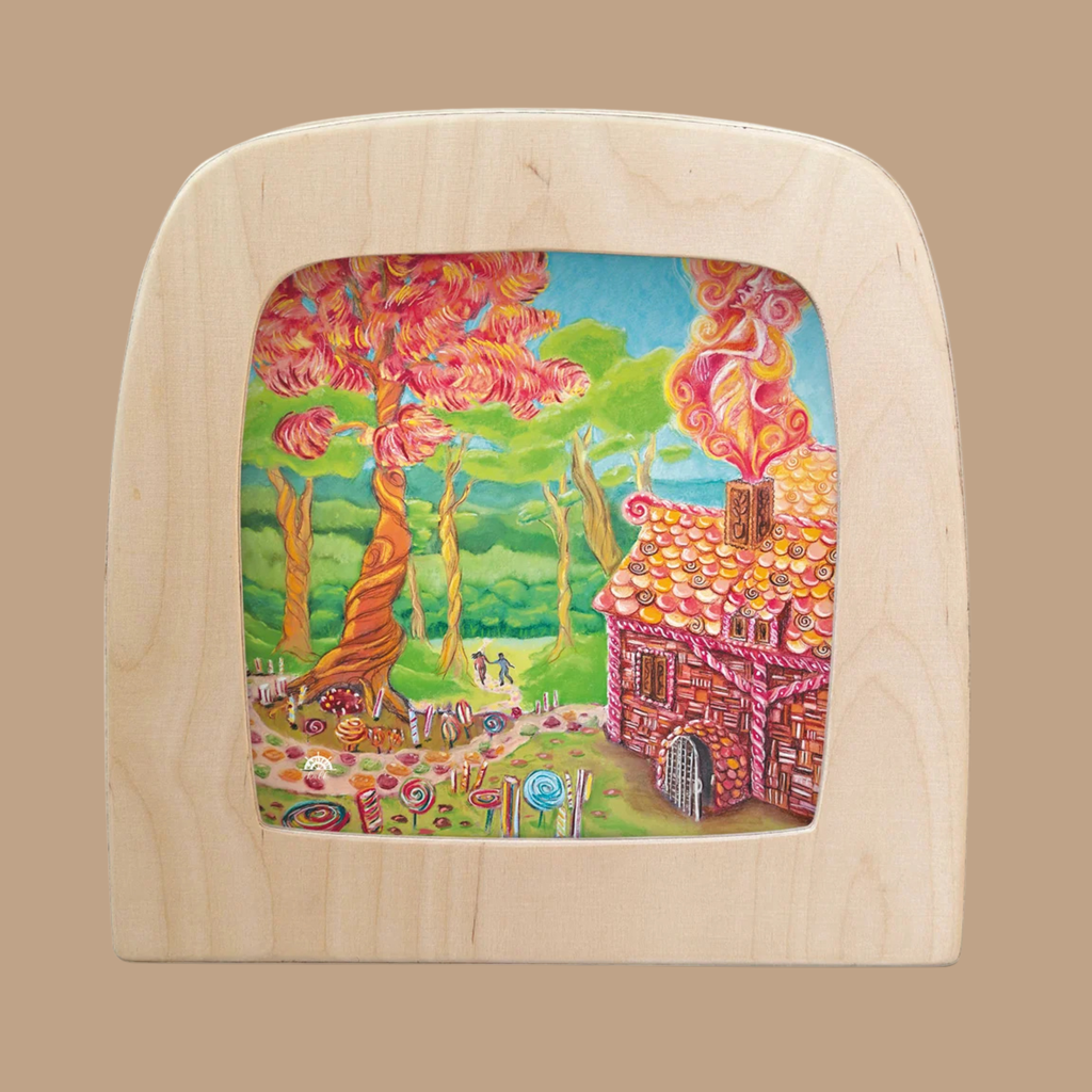 A whimsical silhouette depicting Hansel and Gretel by a candy house in the forest is beautifully showcased as the “Silhouette Only - Hansel and Gretel Silhouette for Toverlux Lamp,” framed in light wood with a plain brown background. This enchanting design evokes the charm of classic fairy tales, perfectly complementing the magical ambiance of your Toverlux Lamp.