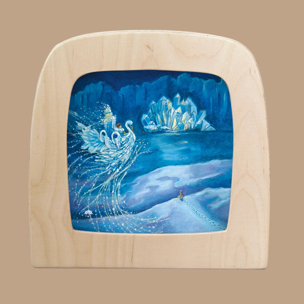 The “Silhouette Only - Snow Queen Silhouette for Toverlux Lamp” features six glowing swans soaring above snowy ground with a small figure below, creating enchanting Magic Silhouettes. Icy mountains and a luminous castle under a blue night sky add to the scene’s charm, making this Toverlux silhouette a truly unique piece of home decor.