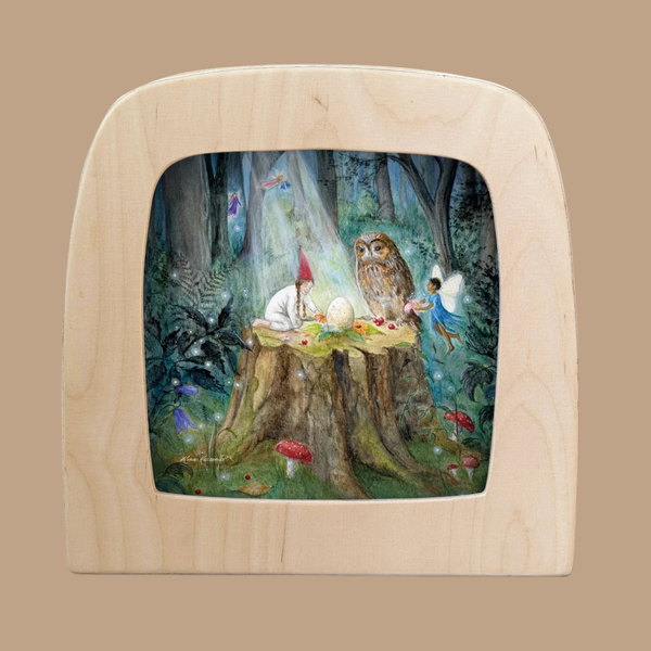 A gnome, fairy, and owl gather around a glowing egg on a tree stump in a magical forest, framed by a light wood arch on a tan background—a captivating scene depicted in the “Silhouette Only - Midsummer Ritual Silhouette for Toverlux Lamp,” an enchanting addition to your Toverlux lamp collection.