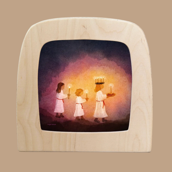 Three children in white robes walk in a line holding candles, with the front child wearing a crown of candles and carrying a tray. This scene is beautifully depicted on the Silhouette Only - Little Lightbearers Silhouette for Toverlux Lamp, which features a light wood border—making it an enchanting piece of home decor or a thoughtful choice for unique gifts.