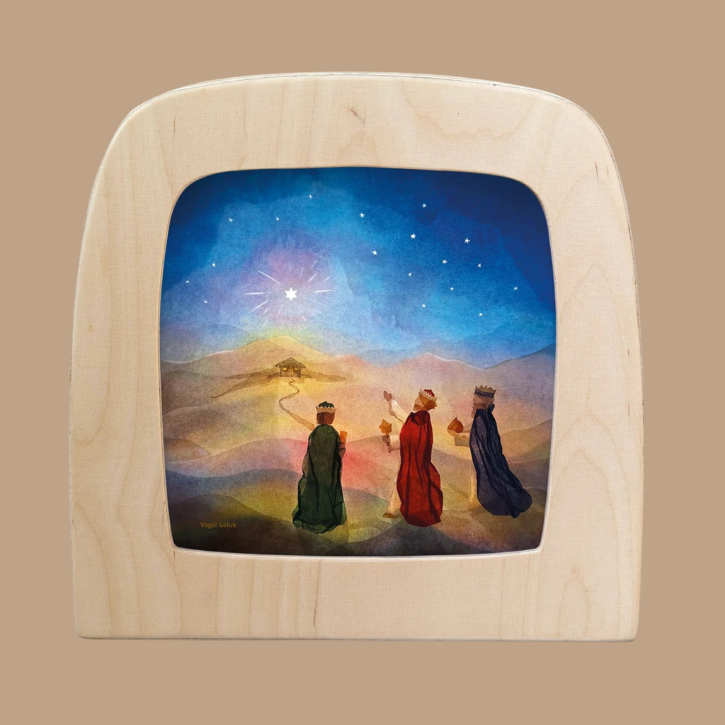 Three figures in colorful robes walk toward a distant house under a starry sky, guided by a shining star. The Silhouette Only - Star Path Silhouette for Toverlux Lamp brings this magical scene to life, adding charm to any home decor with its captivating design.
