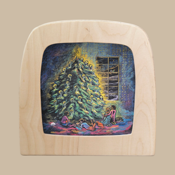 A painted wood silhouette from the Magic Silhouettes collection, "Christmas Lights for Toverlux Lamp," features three children placing gifts under a glowing candle-lit tree in a cozy room—a charming home decor piece.