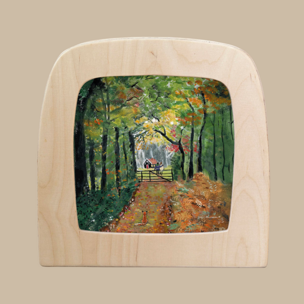 Silhouette Only - Autumn Stroll for Toverlux Lamp features a wooden frame with translucent art of a leafy forest path in autumn, showing a person walking a dog under green and orange trees—perfect for enchanting home decor.