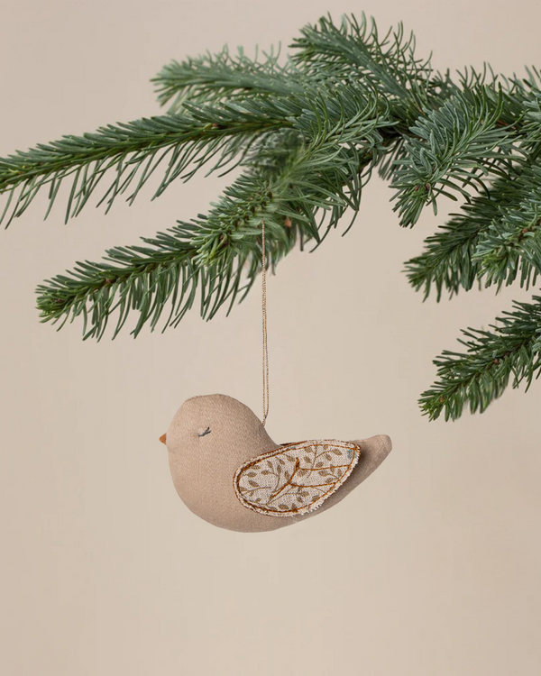 The Maileg Fabric Ornament, Bird - Branches - Blue features delicately embroidered wings and hangs from a pine branch, bringing charm to your Christmas ornament collection against a neutral backdrop.