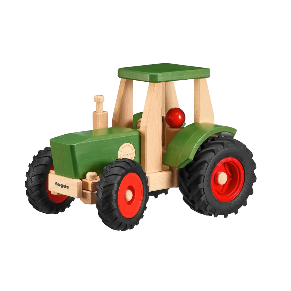 The Maileg x Fagus Limited Edition Tractor Set features a green wooden body, red wheels, black rubber tires, and a small driver figure. With its sturdy design and green roof, it’s perfect for collectors or imaginative play.